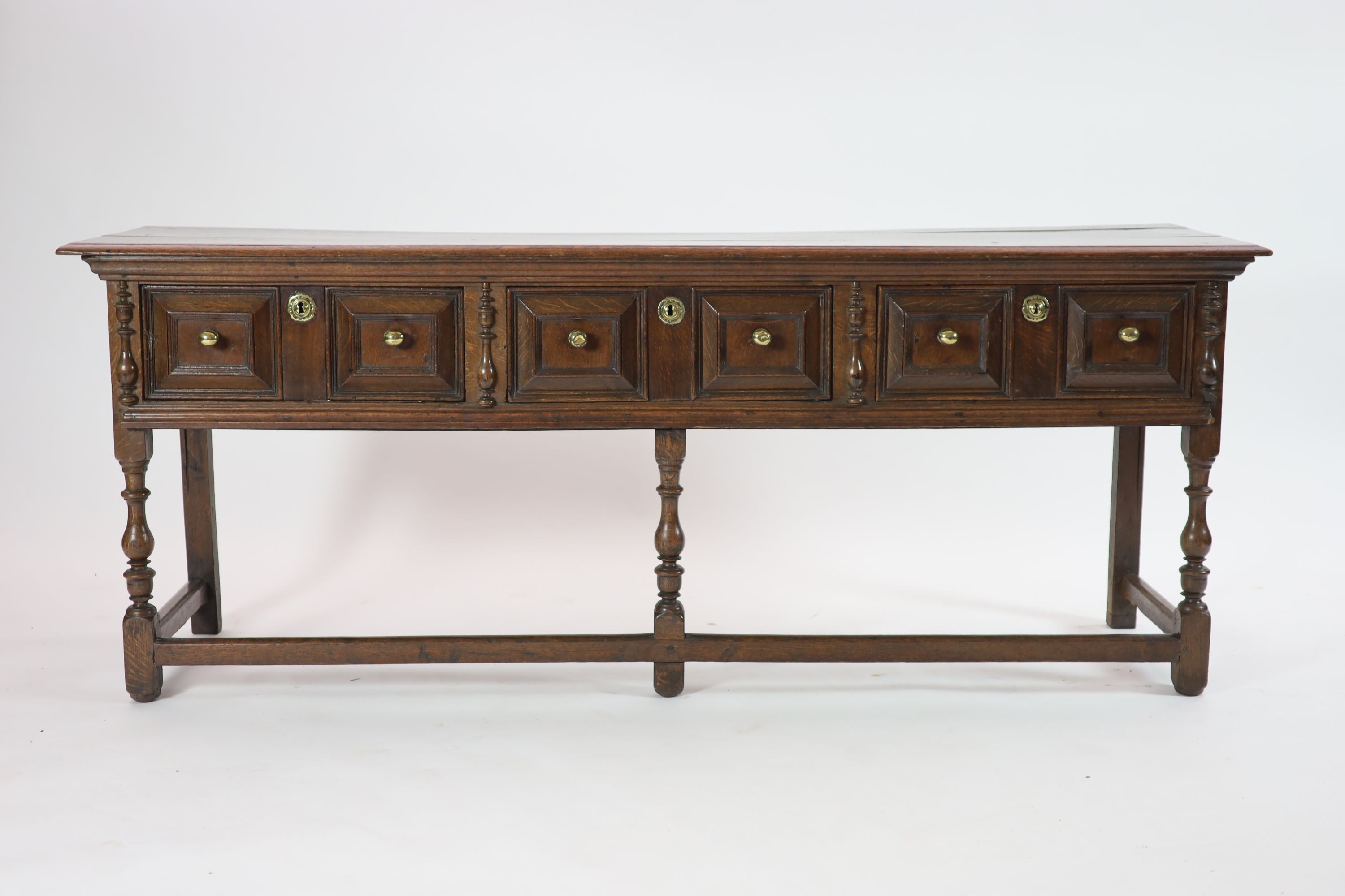 A late 17th century oak low dresser, H 81cm. W 205cm. D 54cm.